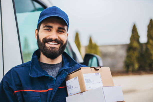 Courier driver handling a delivery from a vehicle